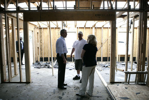 President George W. Bush talks with Cheryl Woodward of Long Beach, Miss. and a construction worker, Thursday, March 1, 2007, during the President’s tour of the neighborhood where homes damaged by Hurricane Katrina have been rebuilt with Gulf Coast grant money. White House photo by Eric Draper