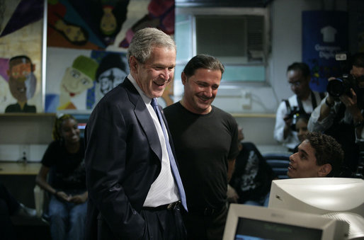 President George W. Bush and Meninos do Morumbi founder Flavio Pimenta share a bright moment with a student during a visit to the center Friday, March 9, 2007, by the President and Mrs. Laura Bush in Sao Paulo. White House photo by Eric Draper