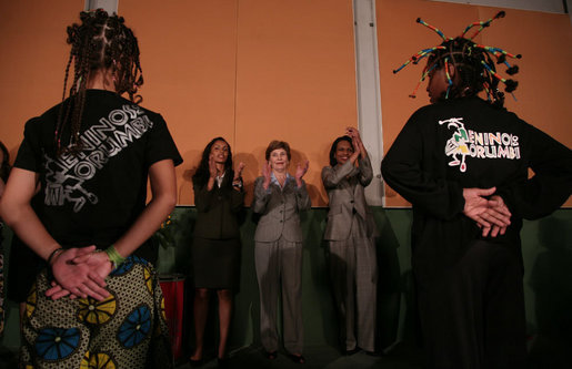 Mrs. Laura Bush and Secretary of State Condoleezza Rice clap to the music as they watch 80 children sing and dance Friday, March 9, 2007, during a visit to Sao Paulo's Meninos do Morumbi. White House photo by Paul Morse