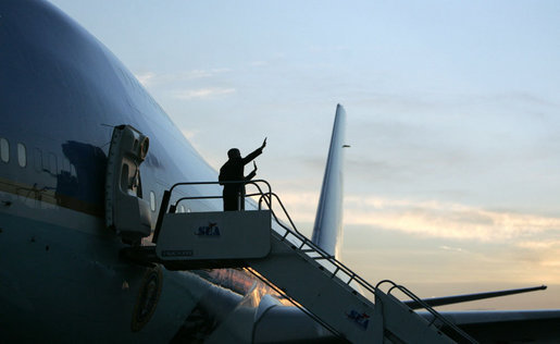 President George W. Bush and Mrs. Laura Bush are silhouetted as they wave goodbye to Sao Paulo Friday, March 9, 2007, before boarding Air Force One en route to Uruguay on their six-day, five-country, Latin American tour. White House photo by Paul Morse