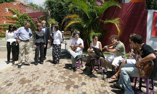 Mrs. Laura Bush listens to a musical performance at Projeto Aprendiz Friday, March 9, 2007, in Sao Paolo, Brazil. Developing the concept of the neighborhood as a school, the program supplements school education with a wide range of community-based activities. The work carried out by Aprendiz has been recognized by UNICEF as a best practice project to be disseminated worldwide. White House photo by Shealah Craighead