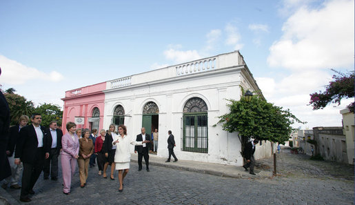 Mrs. Laura Bush and Mrs. Maria Auxiliadora Delgado de Vazquez, wife of President Tabare Vazquez of Uruguay, listen as Maria Dominguez tells them about historic Colonia del Sacramento during a walking tour Saturday, March 10, 2007. White House photo by Shealah Craighead