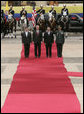 President George W. Bush stands at attention during an arrival ceremony with Colombian President Alvaro Uribe at Casa de Narino in Bogotá, Colombia, Sunday, March 11, 2007. White House photo by Paul Morse