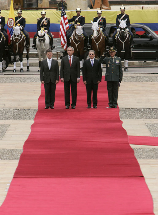 President George W. Bush stands at attention during an arrival ceremony with Colombian President Alvaro Uribe at Casa de Narino in Bogotá, Colombia, Sunday, March 11, 2007. White House photo by Paul Morse