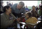 President George W. Bush talks with a woman and young girl Monday, March 12, 2007, during his visit to the Carlos Emilio Leonard School in Santa Cruz Balanya, Guatemala. White House photo by Eric Draper