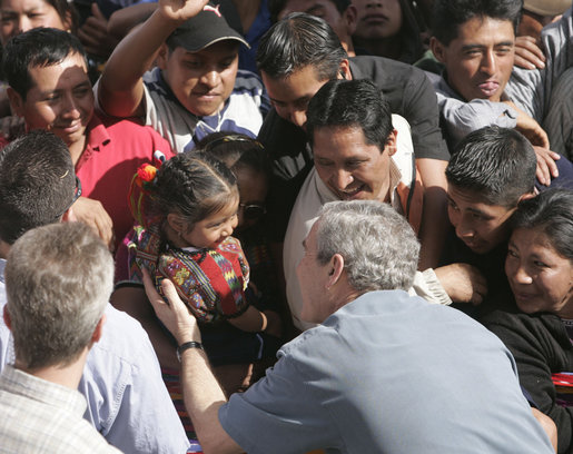 President George W. Bush reaches for a young Guatemalan child during his visit Monday, March 12, 2007, to Santa Cruz Balanya. The President and Mrs. Bush visited three Guatemala villages Monday morning before traveling to Mexico. White House photo by Paul Morse