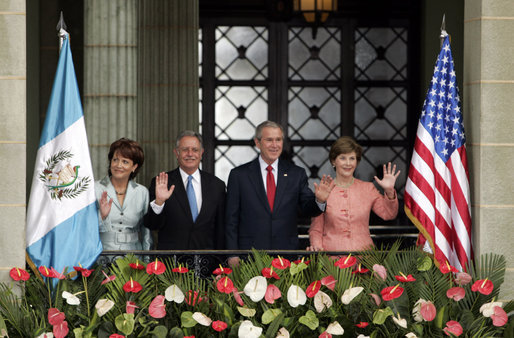 President George W. Bush and Mrs. Laura Bush and President Oscar Berger of Guatemala, and Mrs. Wendy Widmann de Berger wave to the audience Monday, March 12, 2007, during the arrival ceremonies at the Palacio Nacional de la Cultura in Guatemala City. White House photo by Paul Morse