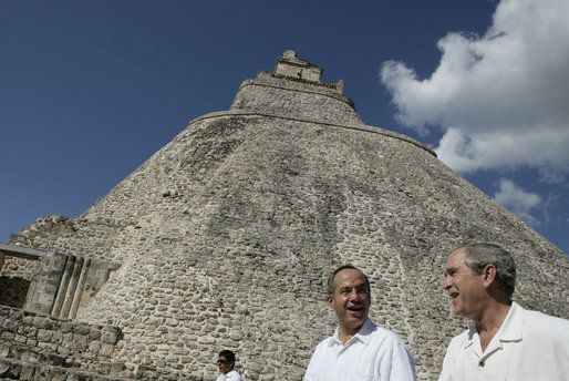 With the Pyramid of the Magician towering in the background, President George W. Bush and President Felipe Calderon of Mexico, tour the Mayan ruins of Uxmal Tuesday, March 13, 2007. White House photo by Eric Draper