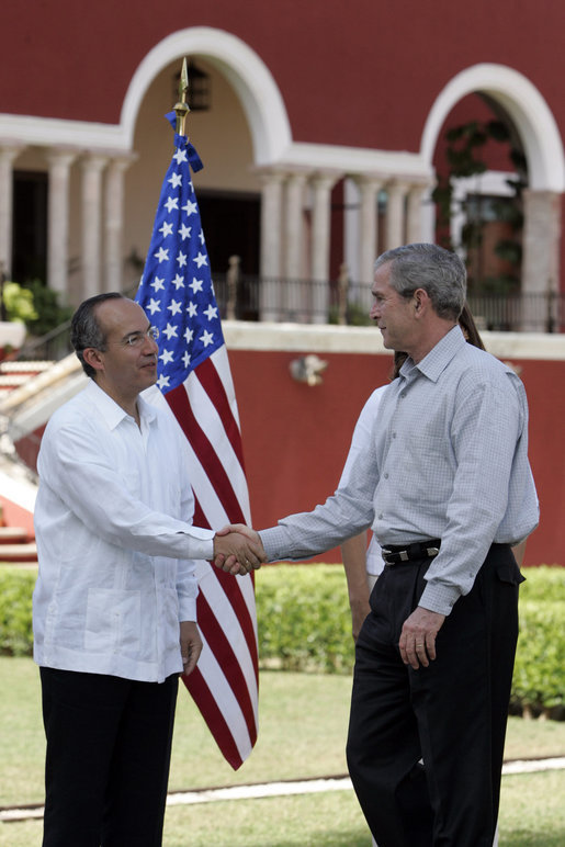 President George W. Bush exchanges handshakes with Felipe Calderon, President of Mexico, during the arrival ceremonies Tuesday, March 13, 2007, welcoming the President and Mrs. Bush to the country. President Calderon told the President, "Mr. President, I have no doubt that together our governments will move forward in the generation of new opportunities of well-being and prosperity for our nations. Please feel very, very welcome to Mexico." White House photo by Paul Morse