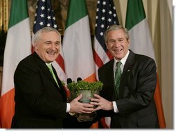 President George W. Bush is presented with a bowl of shamrocks by Ireland's Prime Minister Bertie Ahern at a ceremony in the Roosevelt Room at the White House, March 16, 2007. White House photo by Joyce N. Boghosian