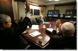 President George W. Bush and Vice President Dick Cheney wave from the Situation Room of the White House Monday, March 19, 2007, as they're joined in a video teleconference by Prime Minister Nouri al-Maliki of Iraq.  White House photo by Eric Draper