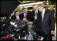 President George W. Bush takes a look under a hood during his tour Tuesday, March 20, 2007, of the Ford Motor Company - Kansas City Assembly Plant in Claycomo, Missouri, joined by, from left, U.S. Rep. Sam Graves, Ford President and CEO Alan Mulally and Ford Group Vice President Derrick Kuzak. White House photo by Eric Draper