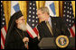 President George W. Bush smiles as he welcomes His Eminence Archbishop Demetrios to the White House Friday, March 23, 2007, to celebrate Greek Independence Day and to recognize the contributions of Greek-Americans to American culture. This year's ceremony also recognized the 40th anniversary of the episcopacy of the Archbishop. White House photo by Eric Draper