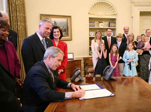 President George W. Bush, joined by the family of former President Lyndon Baines Johnson, signs H.R. 584 designating the U.S. Department of Education in Washington, D.C., as the Lyndon Baines Johnson Federal Building, Friday, March 23, 2007 in the Oval Office. White House photo by Eric Draper