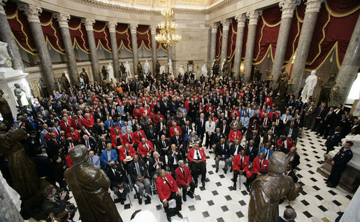 President George W. Bush and Speaker of the House of Representatives Nancy Pelosi stand amidst 300 Tuskegee Airmen during a photo opportunity Thursday, March 29, 2007, in Statuary Hall at the U.S. Capitol. White House photo by Joyce Boghosian