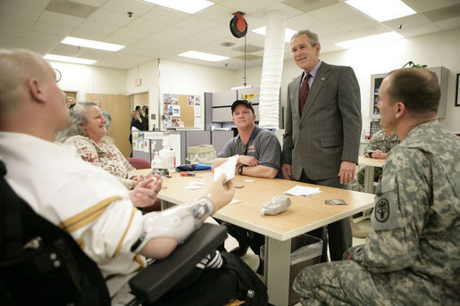 President George W. Bush talks with the Shirley family of Labelle, Fla., Friday, March 30, 2007, during a visit to Walter Reed Army Medical Center in Washington, D.C. Pictured, from left, is U.S. Army Sgt. Luke Shirley, his mother Bonniesue Whitehead, his brother Joshua James Shirley, who is a Specialist in the U.S. Army, and an unidentified hospital staff member. White House photo by Eric Draper