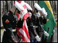 Members of the military honor guard at Camp David bow their heads and hold their hats at the helicopter arrival of Brazilian President Luiz Inacio Lula da Silva, who arrived for a meeting with President George W. Bush, Saturday, March 31, 2007, at the Presidential retreat in Maryland. White House photo by Eric Draper