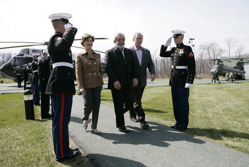 President George W. Bush and Mrs. Laura Bush walk with Brazilian President Luiz Inacio Lula da Silva past an honor guard Saturday, March 31, 2007, during Lula’s welcome to Camp David. White House photo by Eric Draper