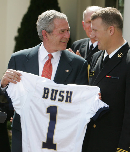 President George W. Bush accepts a jersey from co-captain Rob Caldwell of the U. S. Naval Academy football team, after President Bush presented the team with the Commander-In-Chief trophy in ceremonies in the Rose Garden at the White House, Monday, April 2, 2007. White House photo by Joyce Boghosian