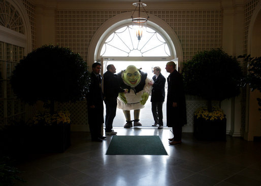 Shrek receives some assistance as he ducks entering the Palm Room of the White House Monday, April 9, 2007. The big guy was on hand to participate in the 2007 White House Easter Egg Roll. White House photo by David Bohrer