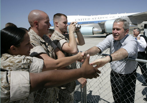 President George W. Bush reaches out to Marines as he prepares to depart the Yuma Marine Corps Air Station in Yuma, Ariz. The stop in the border city was the last before returning to Washington, D. C. after a Easter weekend in Texas. White House photo by Eric Draper