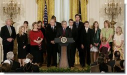 President George W. Bush, joined by military family members, addresses his remarks on the Iraq War supplemental spending bill in the East Room at the White House, Monday, April 16, 2007. President Bush urged Congress to pass an emergency war spending bill, without strings and without further delay.  White House photo by Joyce N. Boghosian