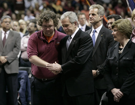 President George W. Bush comforts James Tyger, outgoing Student Government president, Tuesday, April 17, 2007, during the Convocation on the campus of Virginia Tech in Blacksburg, Va. The President and Mrs. Laura Bush attended the service honoring students, faculty and staff who died or were injured in Monday's tragic shooting. White House photo by Eric Draper