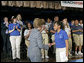 Mrs. Laura Bush thanks 11th grade student Ashley Joplin, who introduced the First Lady, at the New Orleans Charter Science and Mathematics High School Thursday, April 19, 2007, in New Orleans, La. "According to the United States Department of Education, more than 1,000 private and public schools in the Gulf Coast region were damaged or destroyed," said Mrs. Bush. "Today, 94 percent of the schools in Louisiana have reopened. In New Orleans, 58 public schools are now up and running." White House photo by Shealah Craighead