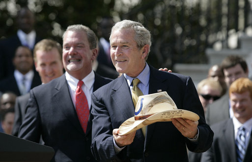 President George W. Bush shows the signed cowboy hat presented to him by Indianapolis Colts team owner and CEO Jim Irsay, left, during the White House ceremony to honor the Super Bowl champions Monday, April 23, 2007. White House photo by Eric Draper