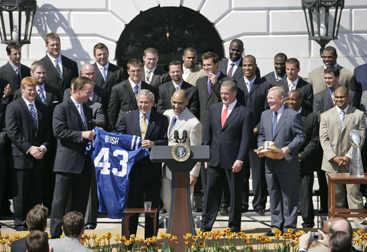 President George W. Bush is presented with a team jersey by Indianapolis Colts’ quarterback Peyton Manning, left, and head coach Tony Dungy during a ceremony honoring their victory in the 2007 NFL Super Bowl Monday, April 23, 2007, on the South Lawn. White House photo by Shealah Craighead