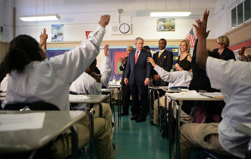 Students in the seventh grade science class at Harlem Village Academy Charter School in New York, raise their hands to answer a question posed by President George W. Bush during his visit to the school Tuesday, April 24, 2007. White House photo by Eric Draper