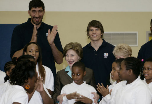 Mrs. Laura Bush, joined by NBA and WNBA players, prepares to pose for photos with fifth-grade students following a basketball game during a Malaria Awareness Day event Wednesday, April 25, 2007, at the Friendship Public Charter School on the Woodridge Elementary and Middle School campus in Washington, D.C. White House photo by Shealah Craighead