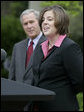 President George W. Bush listens as Andrea Peterson, 2007 National Teacher of the Year, speaks during ceremonies Thursday, April 26, 2007, in the Rose Garden. Said the President, "This is a special day for all who care deeply about education, because we fully understand that without a good teacher it's hard to achieve national goals and objectives." White House photo by Eric Draper