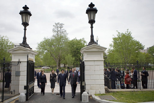 President George W. Bush and Mrs. Laura Bush enter the White House North Lawn with Japanese Prime Minister Shinzo Abe and his wife Mrs. Akie Abe during their walk from the Blair House Thursday, April 26, 2007. President Bush and Mrs. Bush hosted a social dinner for the Prime Minister and his wife. White House photo by Eric Draper