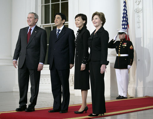 President George W. Bush and Mrs. Laura Bush stand for press photographs with Japanese Prime Minister Shinzo Abe and his wife Mrs. Akie Abe Thursday, April 26, 2007, as they arrive at the North Portico for a social dinner at the White House. White House photo by Eric Draper