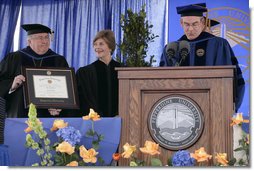 Mrs. Laura Bush receives an honorary Doctor of Laws degree from Dr. Andrew K. Benton, President of Pepperdine University Saturday, April 28, 2007, as Pepperdine Board of Regents member Eff W. Martin, delivers the Conferring Statement. The presentation came during the commencement ceremonies for the Class of 2007 at Pepperdine's Seaver College in Malibu. White House photo by Shealah Craighead