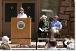 Mrs. Laura Bush speaks to a crowd of about 160 people Sunday, April 29, 2007, during the rededication ceremony of the Zion National Park Nature Center in Springdale, Utah. Interior Secretary Dirk Kempthorne is pictured at the far right. Designed by Gilbert Stanley Underwood in 1934, the center was renovated with new insulation, updated exterior side paneling and restrooms. White House photo by Shealah Craighead