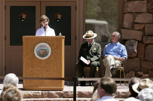 Mrs. Laura Bush speaks to a crowd of about 160 people Sunday, April 29, 2007, during the rededication ceremony of the Zion National Park Nature Center in Springdale, Utah. Interior Secretary Dirk Kempthorne is pictured at the far right. Designed by Gilbert Stanley Underwood in 1934, the center was renovated with new insulation, updated exterior side paneling and restrooms. White House photo by Shealah Craighead