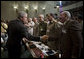 President George W. Bush reaches out to Mr. Shahib Hamad Adnan, Director of Policy and Requirements for the Iraq Defense Department, after delivering remarks Tuesday, May 1, 2007, to the CENTCOM Coalition Conference at MacDill Air Force Base in Tampa. With them are, from left: Mr. Mowaffak Al Rubaie, Iraqi National Security Advisor; Lt. General Yacoob Abdul-rizzaq, Deputy Chief of Staff for Iraq Joint Forces; and Major General Abdul Hasan Mohsen, Director General of Directorate of Border Enforcement. White House photo by Eric Draper