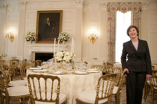 Mrs. Laura Bush describes the table setting arrangements for members of the media for the State Dinner at the White House Monday, May 7, 2007, hosted by President George W. Bush and Mrs. Bush in honor of Her Majesty Queen Elizabeth II and His Royal Highness The Prince Philip, Duke of Edinburgh. White House photo by Shealah Craighead