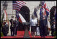 President George W. Bush stands with his hand over his heart during the playing of America's national anthem during the Arrival Ceremony for Her Majesty Queen Elizabeth II and His Royal Highness The Prince Philip Duke of Edinburgh Monday, May 7, 2007, on the South Lawn. White House photo by Lynden Steele