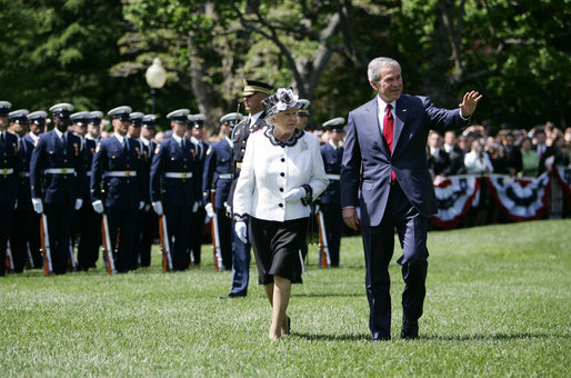 President George W. Bush waves to guests as he escorts Her Majesty Queen Elizabeth II of Great Britain during a review of the troops Monday, May 7, 2007, at the state arrival ceremony on the South Lawn of the White House. White House photo by David Bohrer