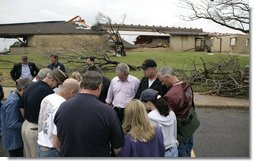 President George W. Bush joins townspeople in prayer Wednesday, May 9, 2007, as he toured a neighborhood in the tornado-ravaged community of Greensburg, Kansas. At least 10 people died in the Friday night storm that destroyed nearly 95 percent of the town. White House photo by Eric Draper