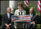 Mrs. Laura Bush is joined by U.S. Secretary of the Interior Dirk Kempthrone, left, and Jon Nau III, chairman of the Advisory Council on Historic Preservation, as she addreses guests in the White House Rose Garden, Wednesday, May 9, 2007, during the Preserve America President Awards ceremony. White House photo by Joyce Boghosian