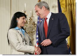 President George W. Bush shakes hands with military spouse Michele Langford of Alameda, Calif., a recipient of the President’s Volunteer Service Award Friday, May 11, 2007, presented in the East Room of the White House during a celebration of Military Spouse Day. White House photo by Eric Draper