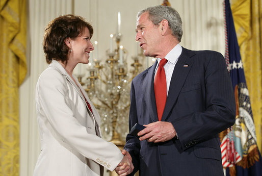 President George W. Bush congratulates military spouse Shannon Maxwell of Jacksonville, N.C., as Maxwell is presented with the President’s Volunteer Service Award Friday, May 11, 2007, in the East Room of the White House during a celebration of Military Spouse Day. White House photo by Eric Draper