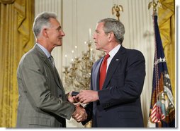 President George W. Bush congratulates military spouse Michael Winton of Wright-Patterson Air Force Base, Ohio, as Winton is presented with the President’s Volunteer Service Award Friday, May 11, 2007, in the East Room of the White House during a celebration of Military Spouse Day. White House photo by Eric Draper