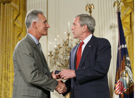 President George W. Bush congratulates military spouse Michael Winton of Wright-Patterson Air Force Base, Ohio, as Winton is presented with the President’s Volunteer Service Award Friday, May 11, 2007, in the East Room of the White House during a celebration of Military Spouse Day. White House photo by Eric Draper