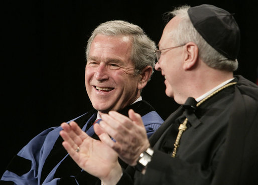 President George W. Bush, sitting with Saint Vincent College Archabbot and Chancellor Rev. Douglas Nowicki, is applauded prior to being introduced Friday, May 11, 2007, to deliver the commencement address to graduates at Saint Vincent College in Latrobe, Pa. White House photo by Joyce Boghosian