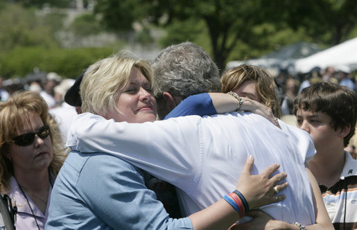 President George W. Bush is embraced by the family of a fallen law enforcement officer, following the President’s address at the annual Peace Officers' Memorial Service at the U.S. Capitol Tuesday, May 15, 2007. White House photo by Joyce Boghosian